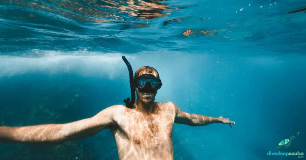 Freediver just below the surface with a mask and snorkel