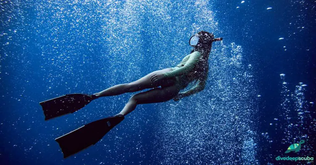 Freediver within lots of bubbles