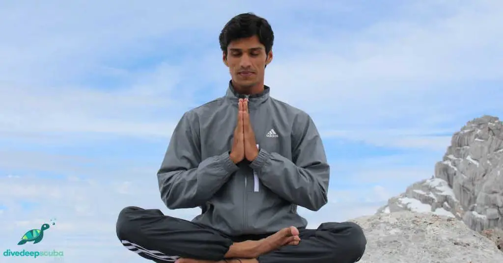 A man breathing on rock edge 