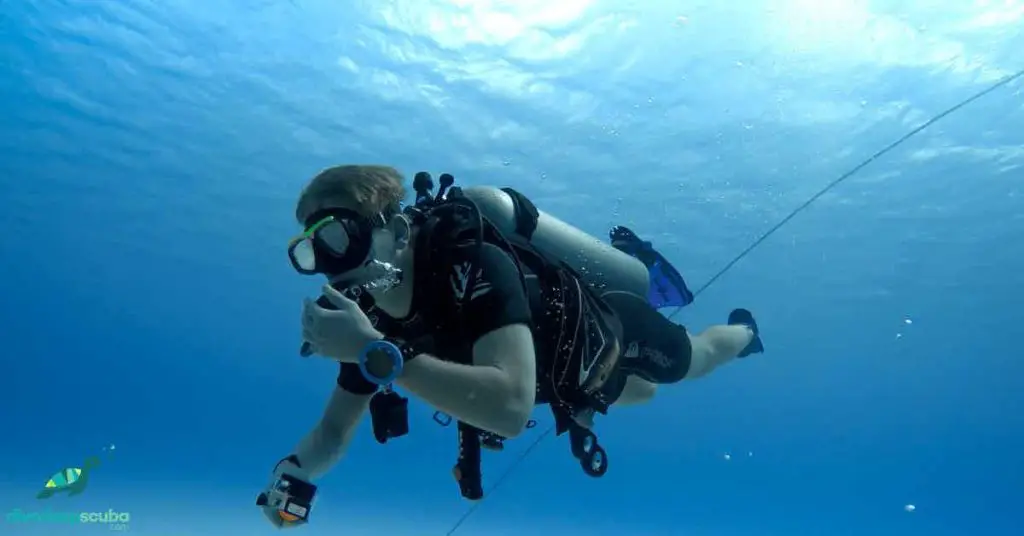 scuba diver swimming in the blue