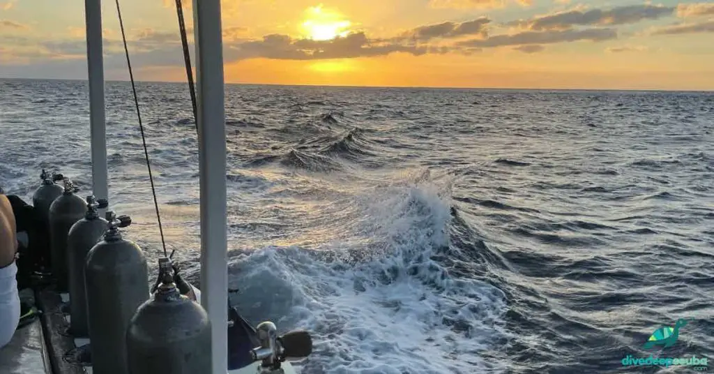 Scuba diving tanks on the boat with a sunset