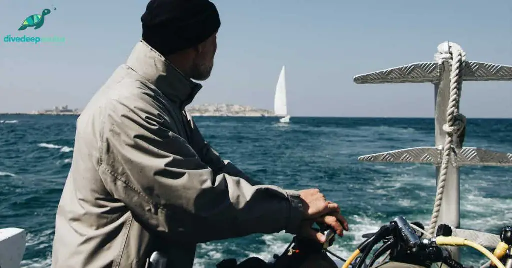 Man on a boat leaning on tank and regulator