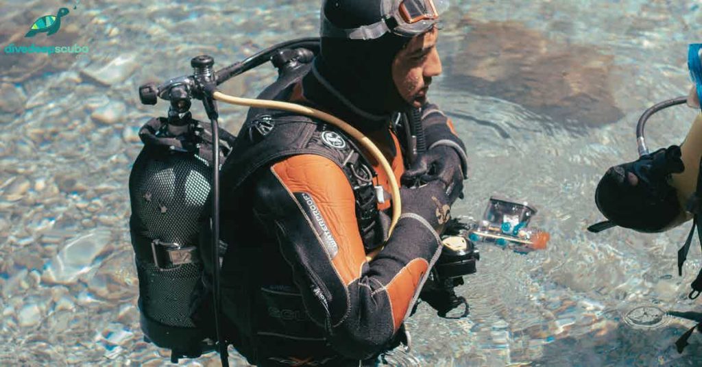 Scuba diver standing in shallow water