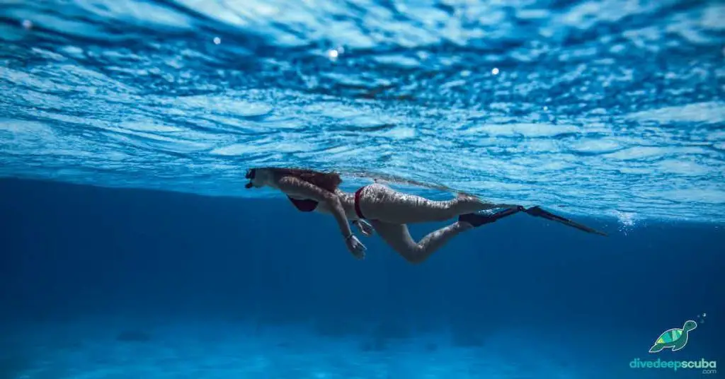 Freediver swimming across the surface