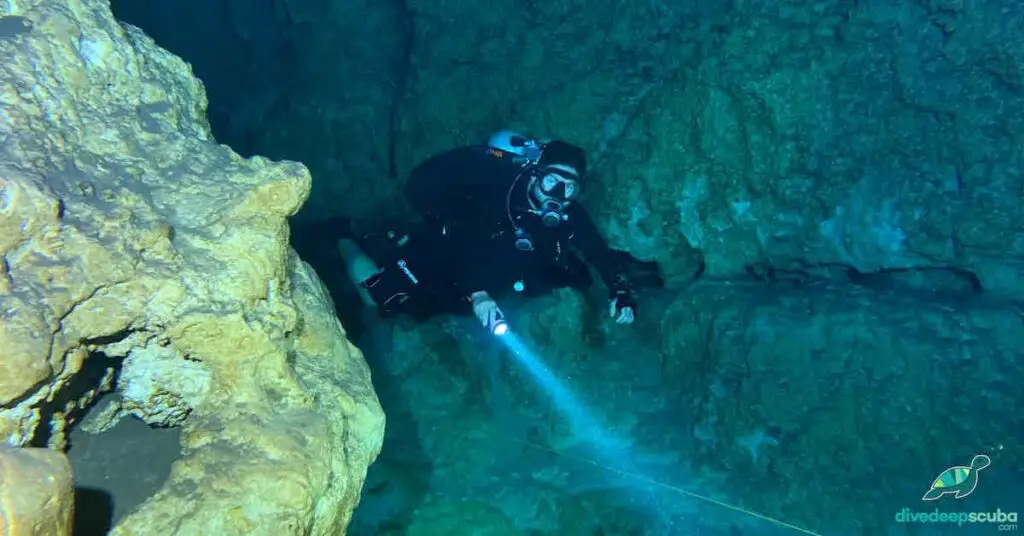 picture of a cave diver with a dive light